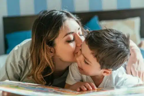 homeschool mom kissing her son