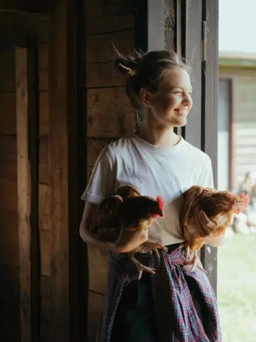 homeschool mom with live hens in her arms