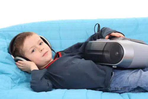 homeschool essentials - kid listening to music on headphones