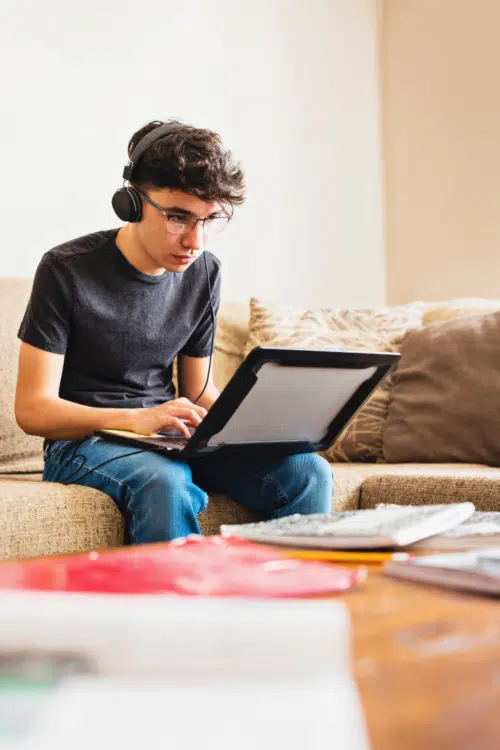 Top Study Tips for Teens - boy listening to headphones while on laptop