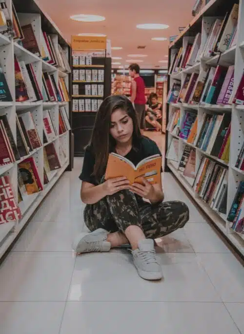 movie from book - teen girl reading in bookstore