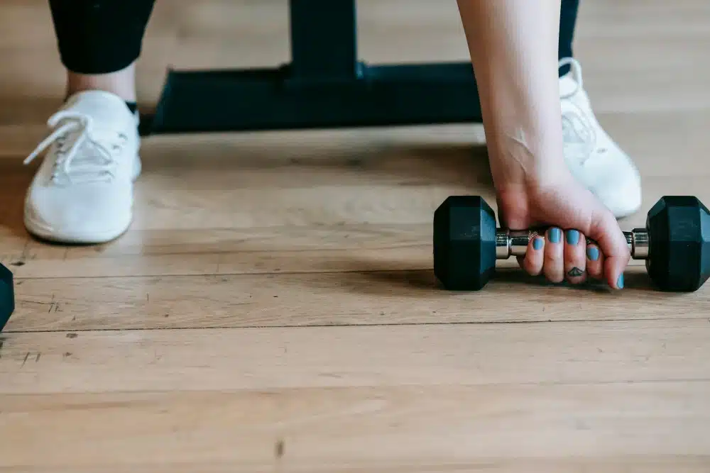 great gifts for the loser in your life - woman with dumbbell 